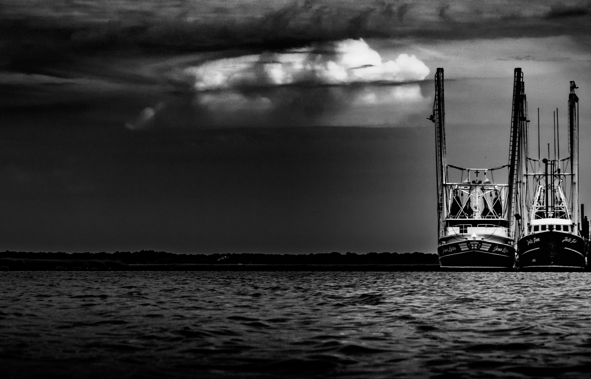 Two shrimp boats isolated beneath a dark Lowcountry storm